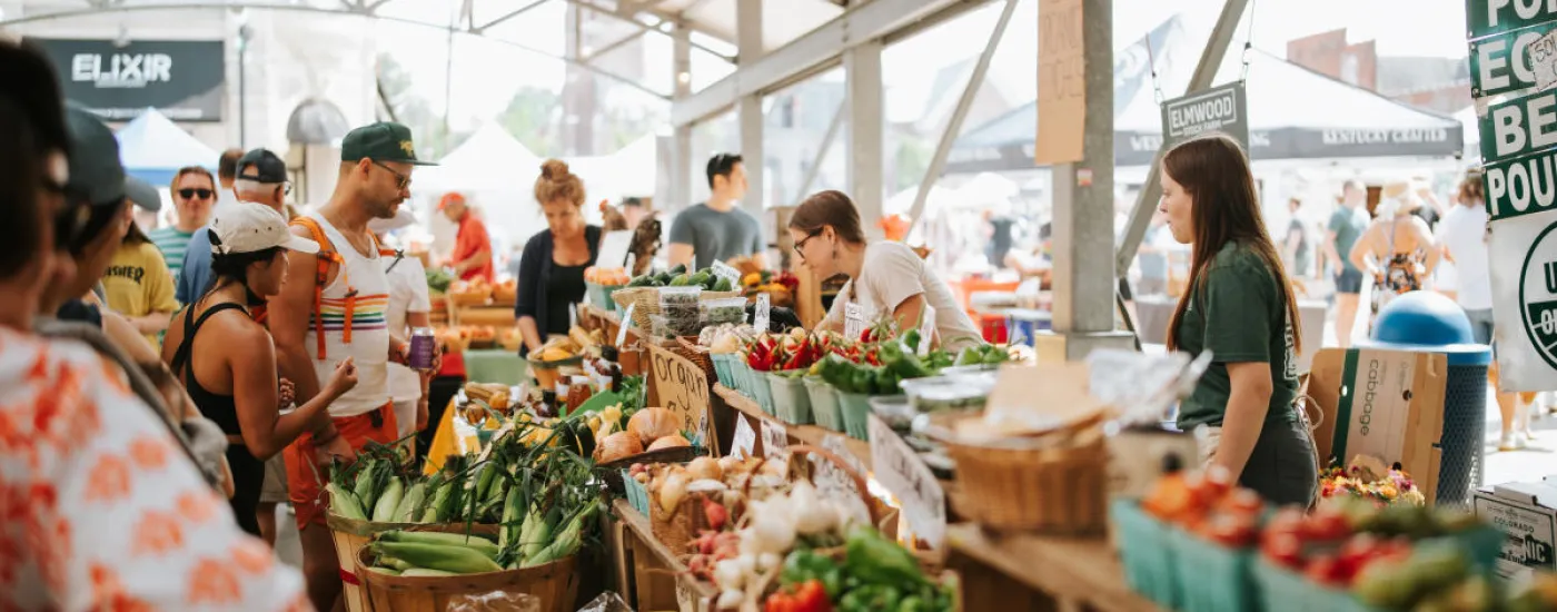 A close up of people visiting stalls at the Lexington Farmer's Market