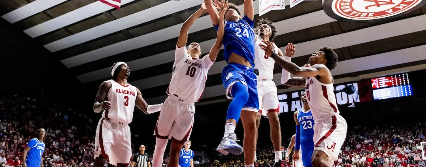 UK men's basketball team playing against Alabama and going for a basket