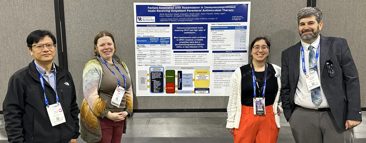 A photo from infectious diseases week 2025 with 4 people flanking a poster presentation in groups of 2