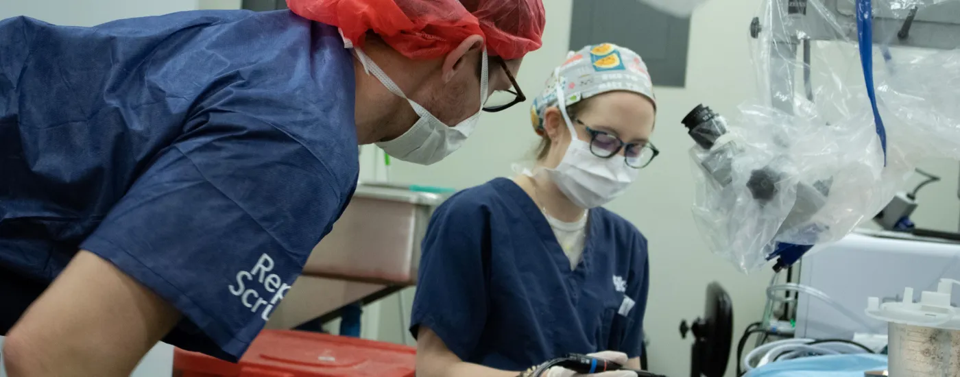 A picture of two otolaryngology residents engaging in a simulation in a temporal bone lab