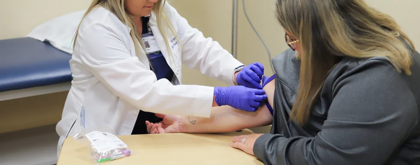doctor administers shot to patient