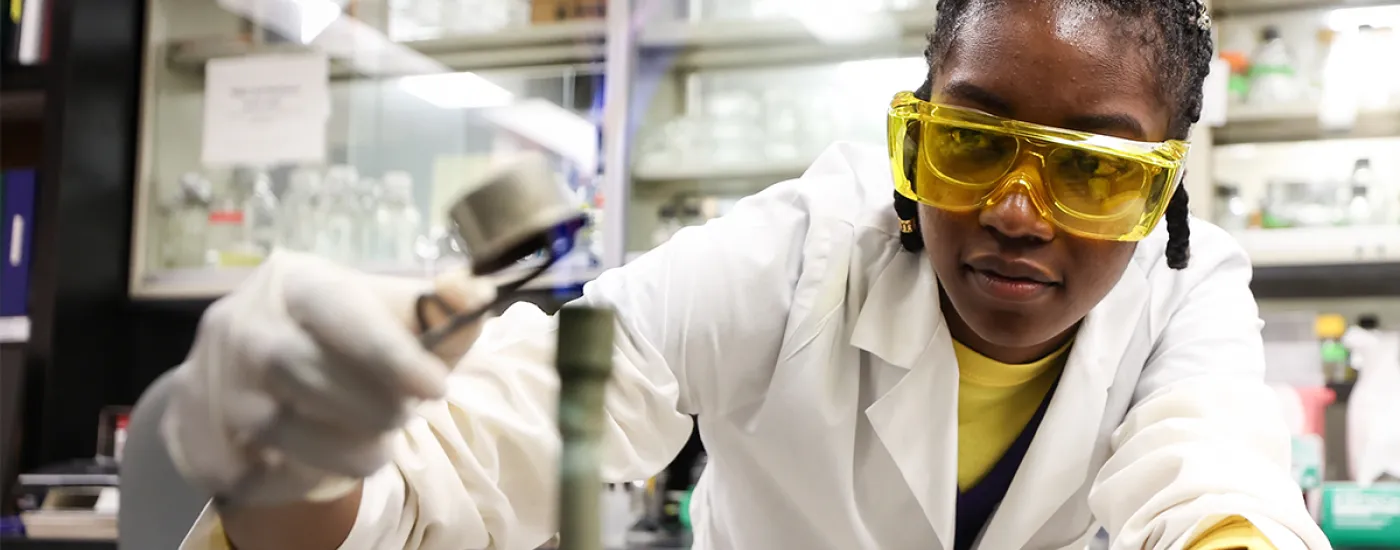 Young woman wearing googles in lab
