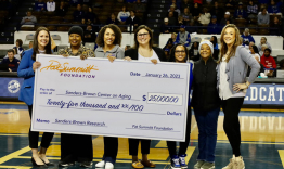 The Pat Summitt Foundation presenting a $25,000 check to UK's Sanders-Brown Center on Aging during the women's basketball game