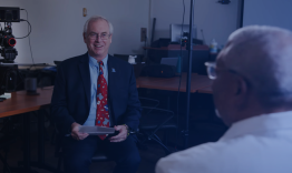 the dean interviewing a department chair in front of a camera