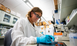 Murphy Byrd with a petri dish in the Ann Stowe laboratory.