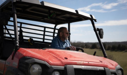 Howard Galbreath driving an ATV vehicle on his farm