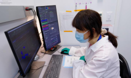 Xia Liu working at a lab computer.