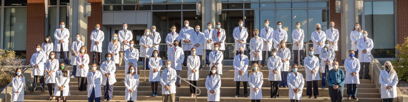 Neurology students on the steps of a COM building.