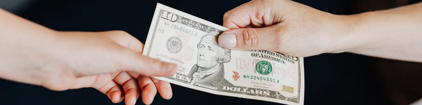 10 dollar bill changing hands
