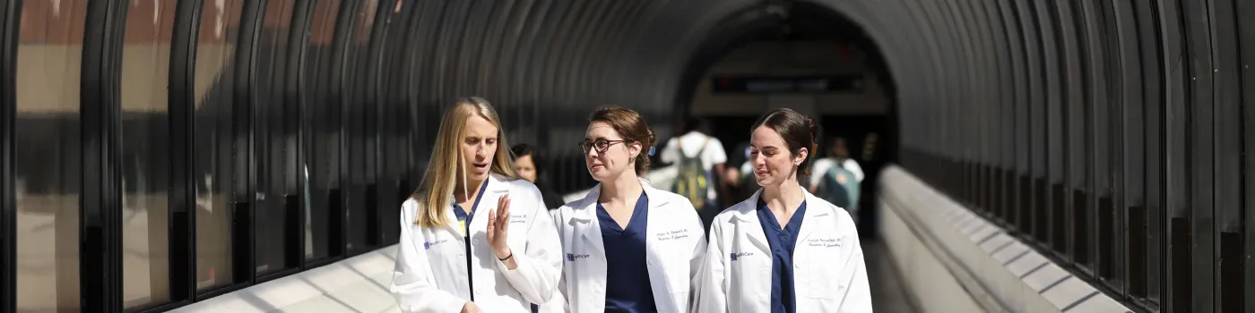 OB-GYN residents walking and talking 
