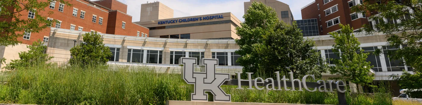 Photo of UK Healthcare sign with Chandler Hospital facility and Children's Hospital facility looming behind it