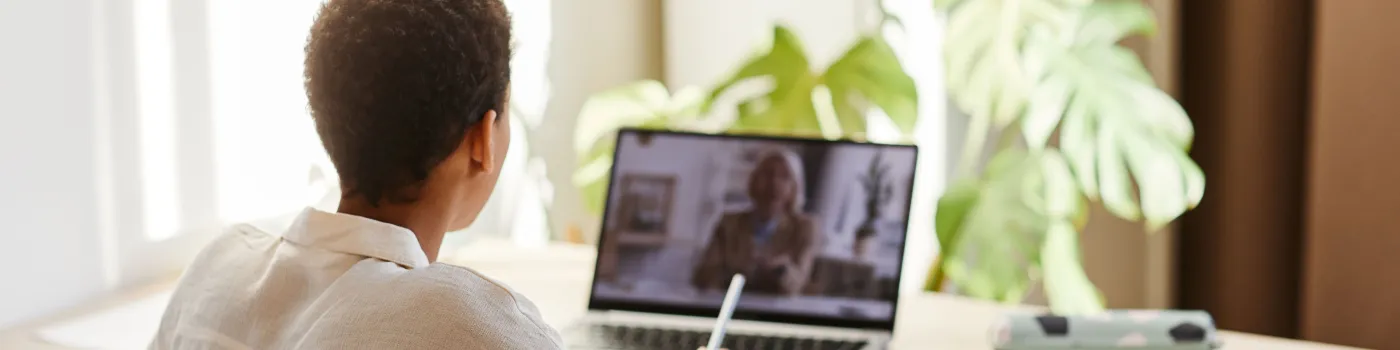 woman sitting at a computer taking an online class