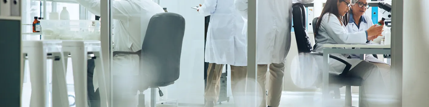 Lab with researchers at desks and walking through