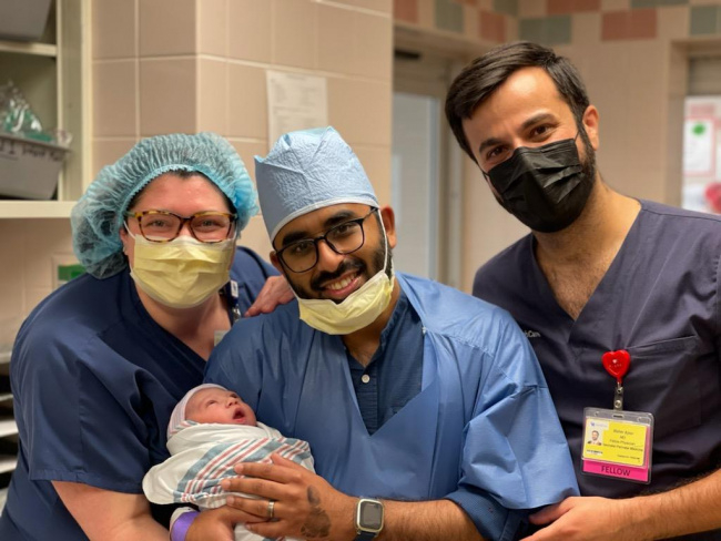 L to R: Drs. Ali Slone and Maher Ajour visit with Dr. Akhtar after the birth of his precious baby girl.