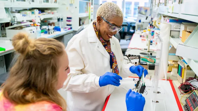 Dr. Yvonne Fondufe-Mittendorf in laboratory with unnamed person