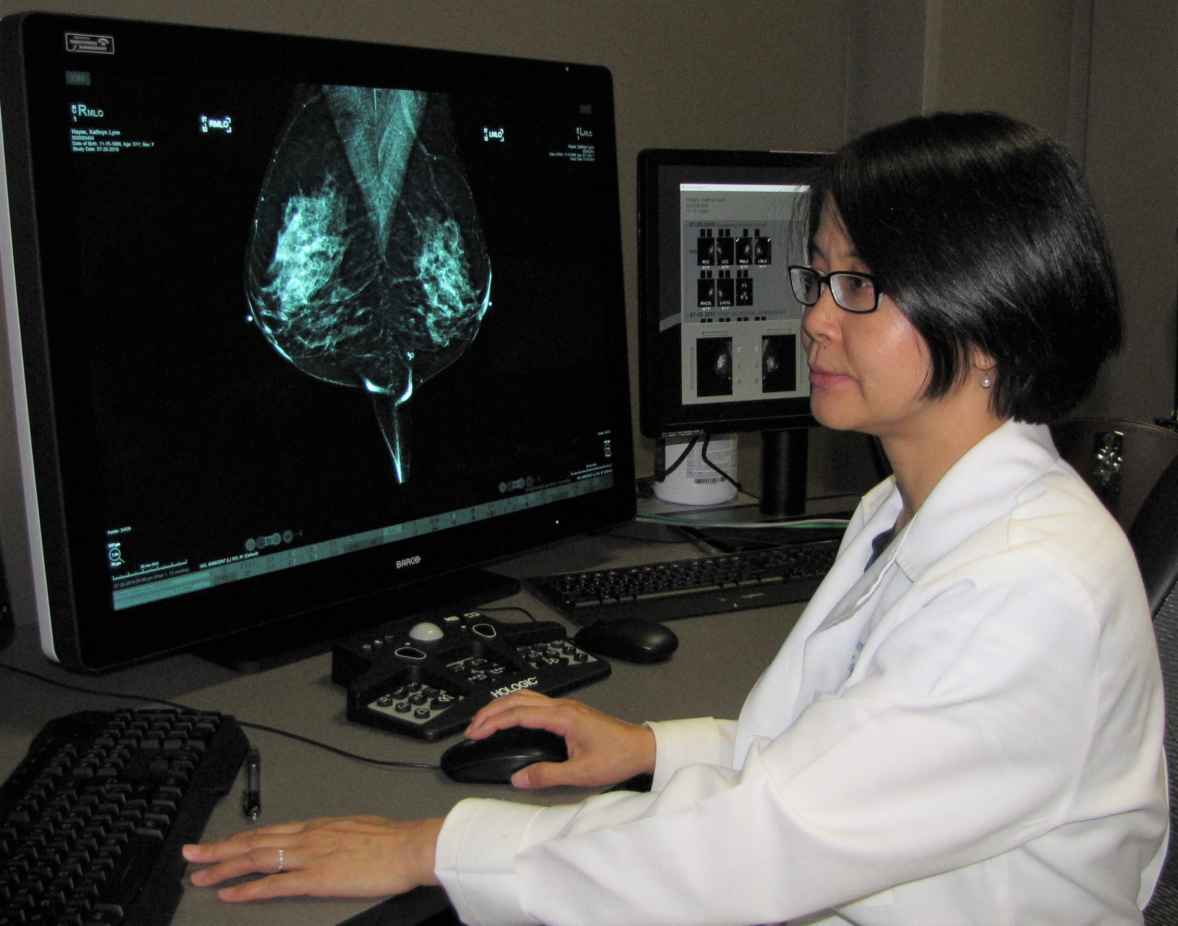 researcher with breast imaging on computer screen