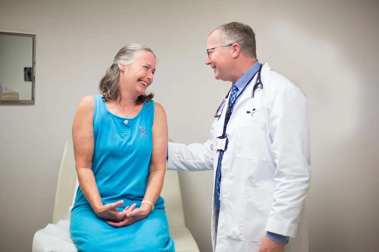 doctor speaking with patient on examination table