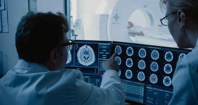 researchers looking at brain scans
