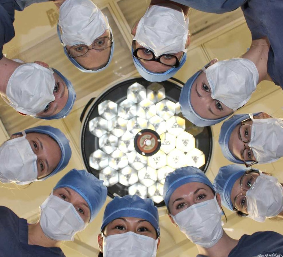 all-woman surgeon team around and OR light