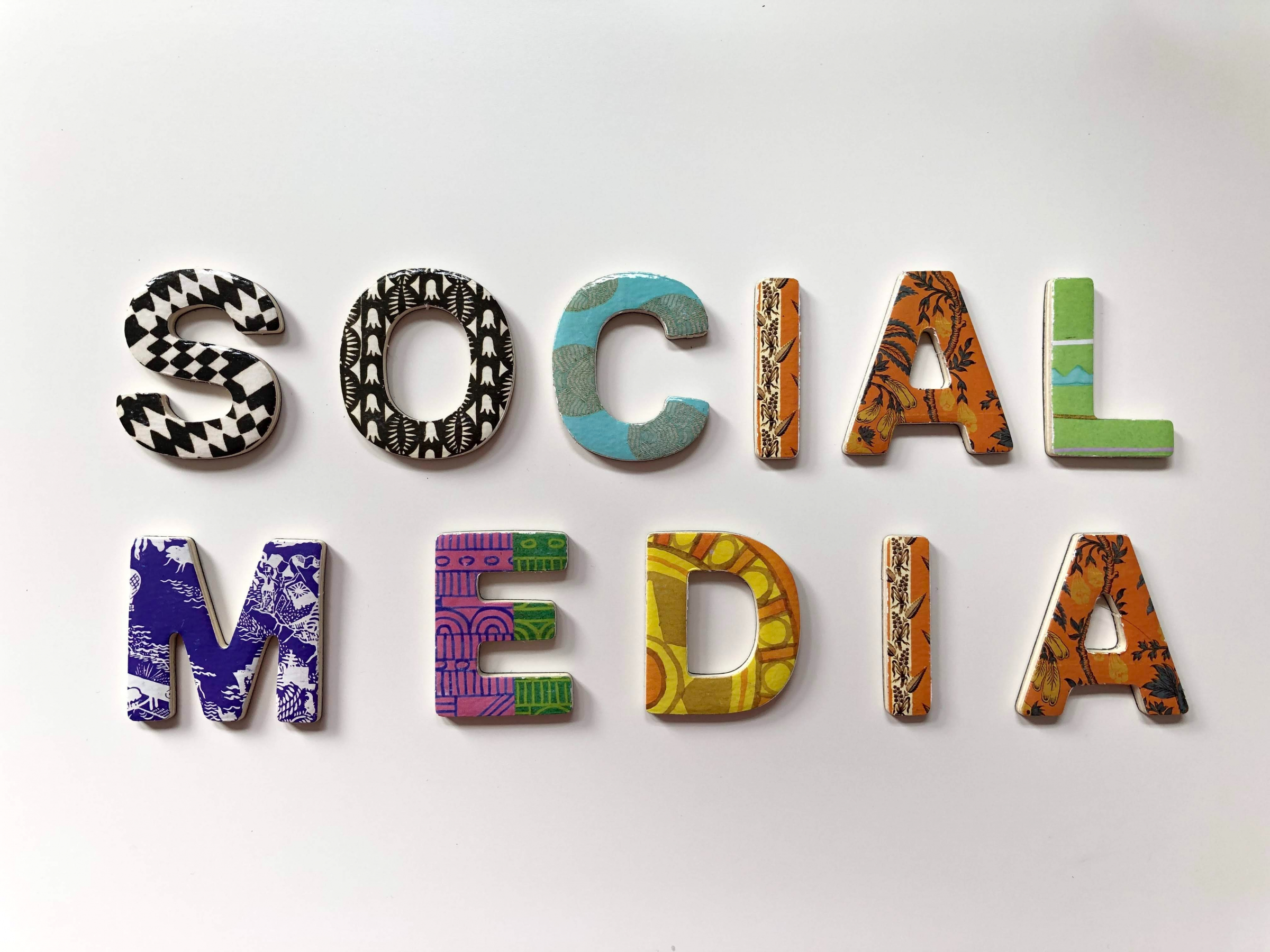 the words 'social media' spelled out in tiles