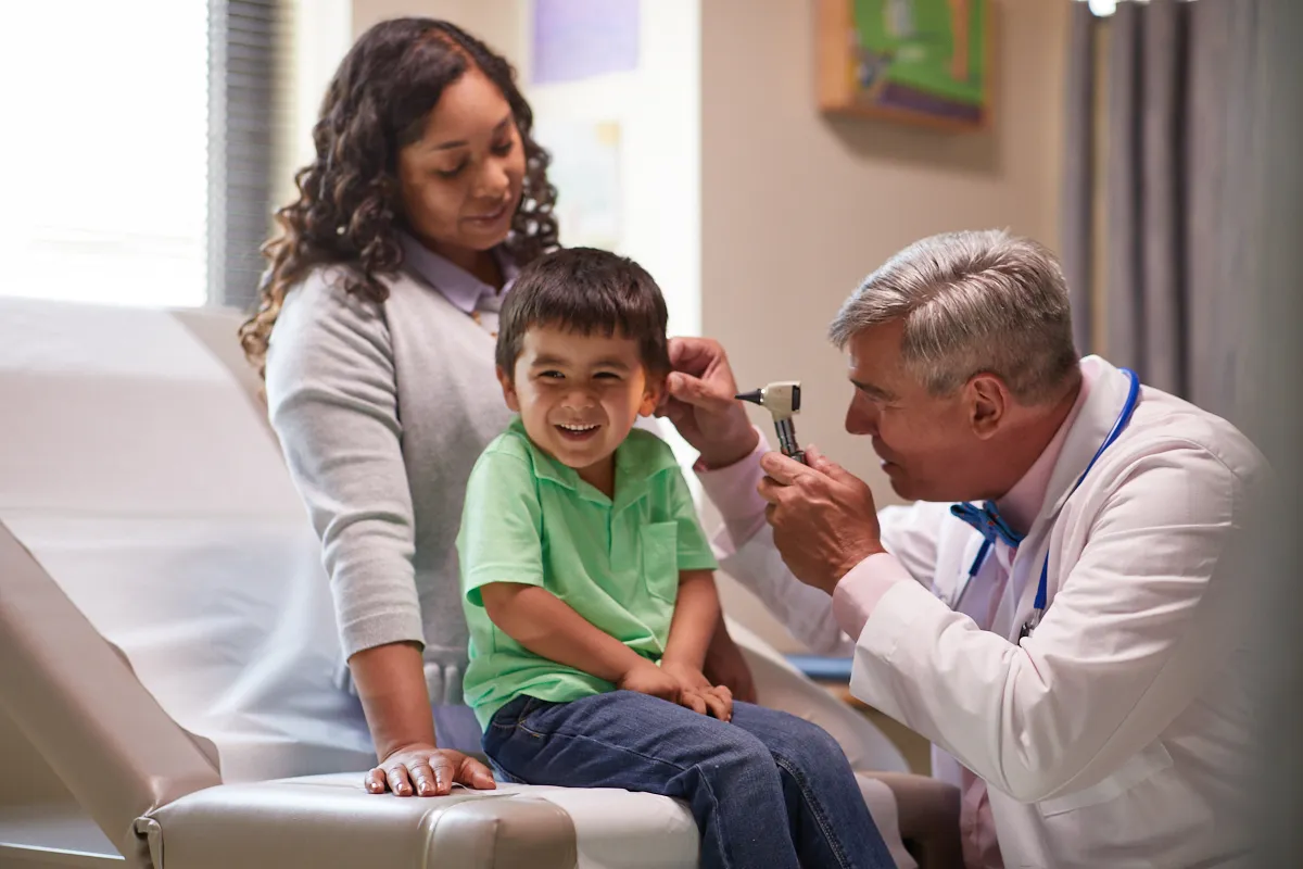 young patient getting an ear exam from a dr
