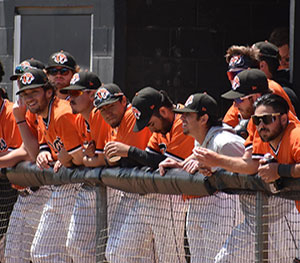 group of Georgetown College baseball players standing against fence