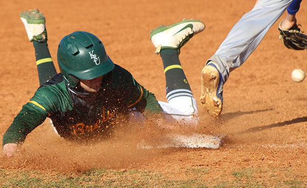 Kentucky State University baseball player sliding into a base