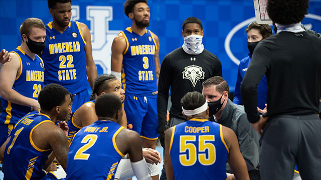 Morehead State basketball team in a huddle during a game