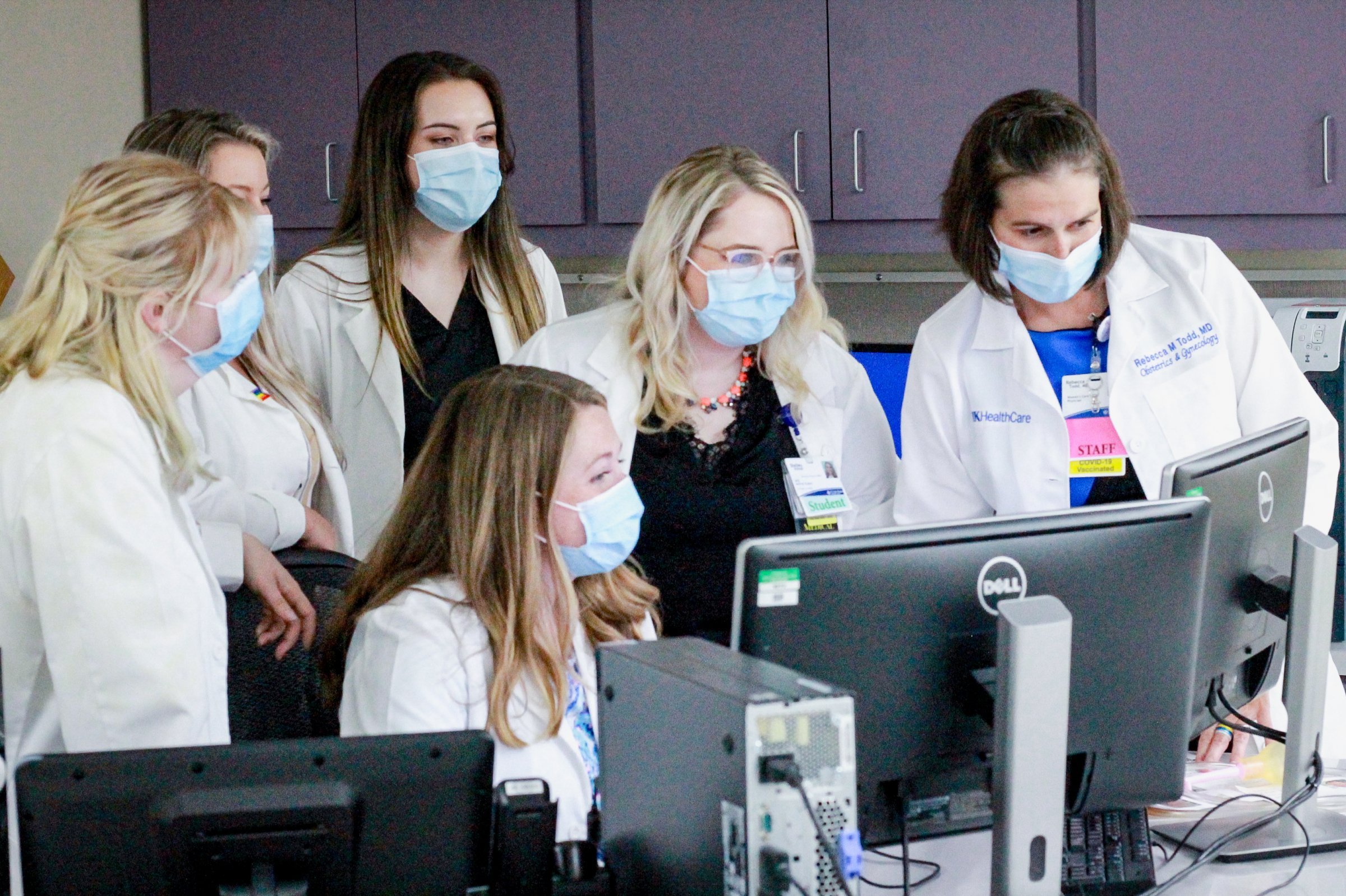 Rebecca Todd, MD with students looking at computer screen