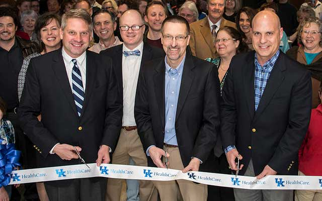  Bo Cofield, Dr. Andrew Pearson and John Phillips are joined by ophthalmology faculty and staff and their family members for a ribbon cutting ceremony of the UK HealthCare Advanced Eye Care Clinic