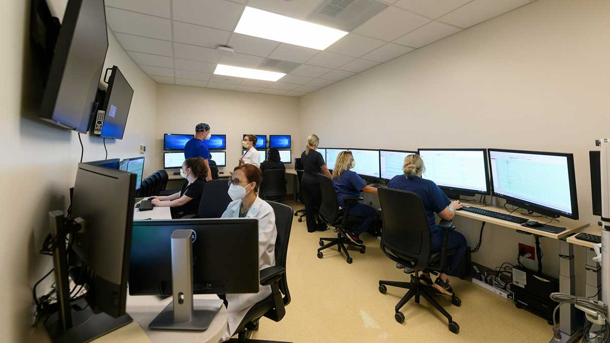 Kentucky Neuroscience Institute monitoring room; lots of computers, screens, and personnel