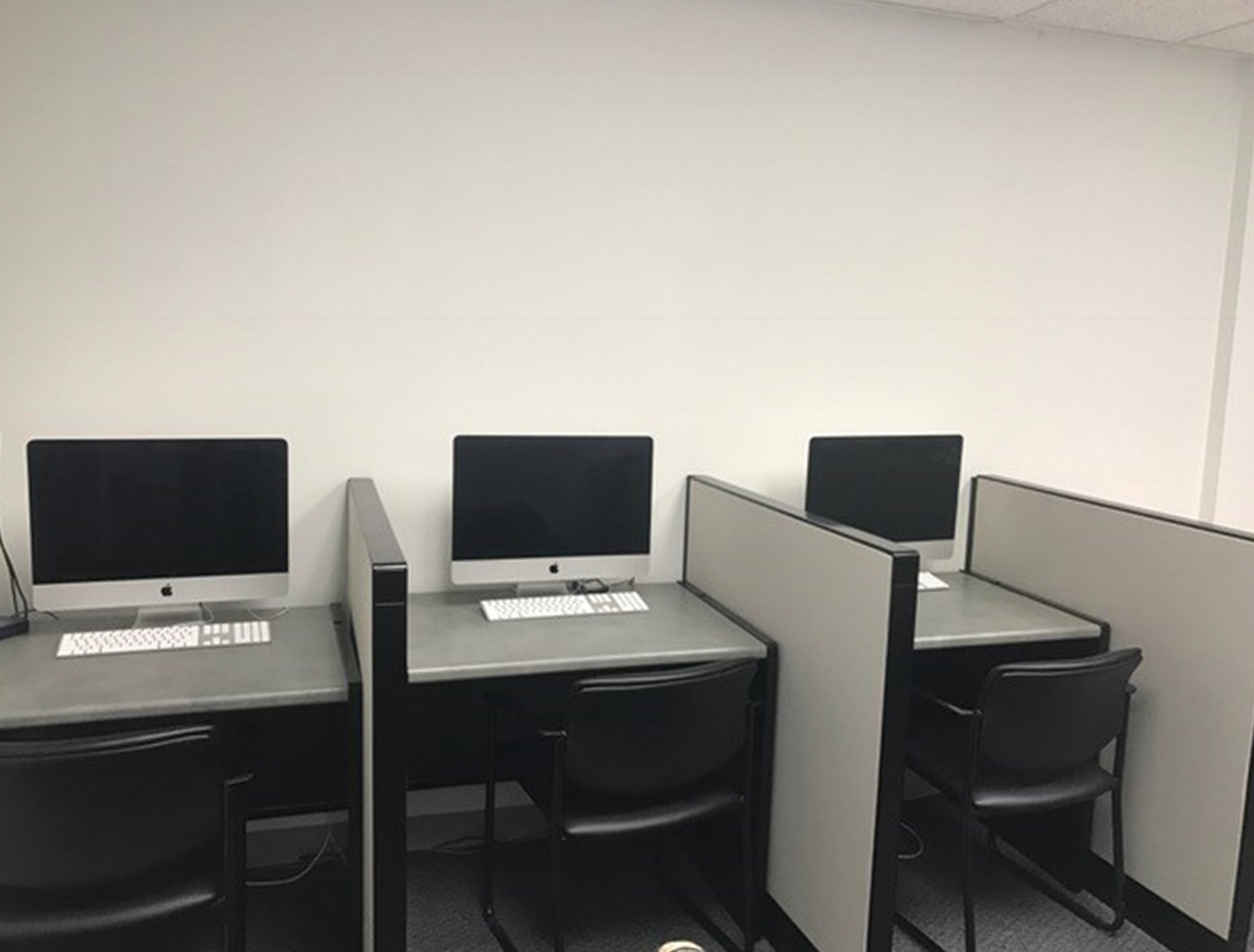 Computer lap with three iMac stations