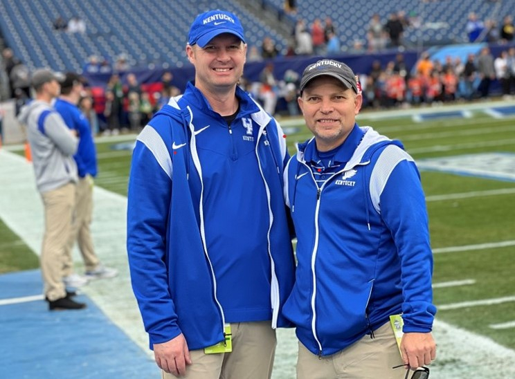 Dr. Kyle Smoot and Dr. Robert Hosey standing together on the UK football field.