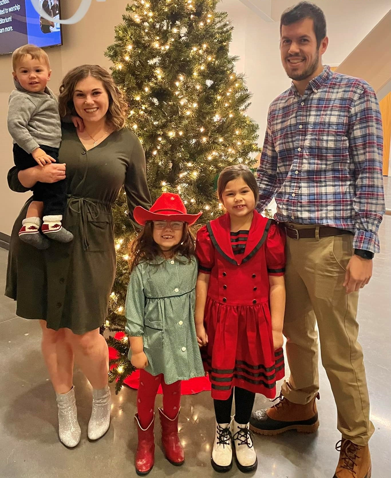 Dr. Hubbard and his wife and three children standing by a holiday tree