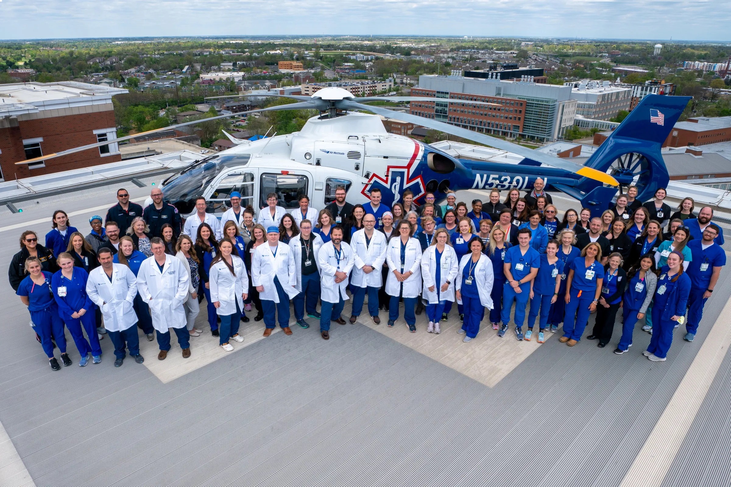 Group of trauma professionals gathered in front of a helicopter