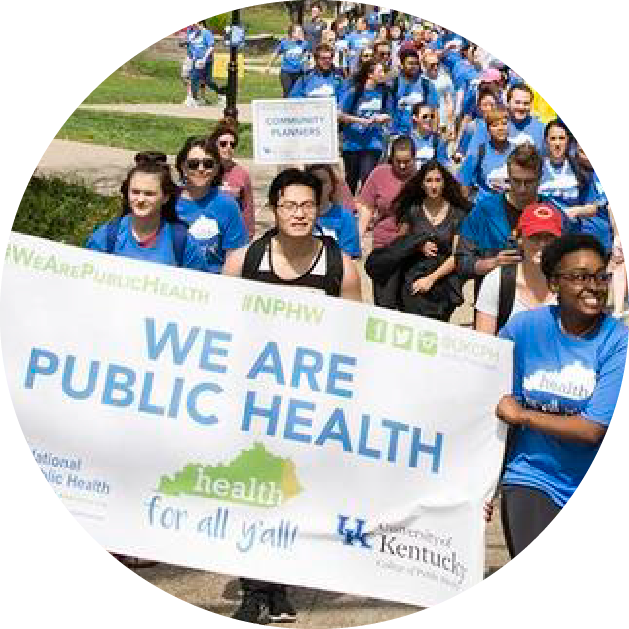 students marching for public health with a banner that says "we are public health"