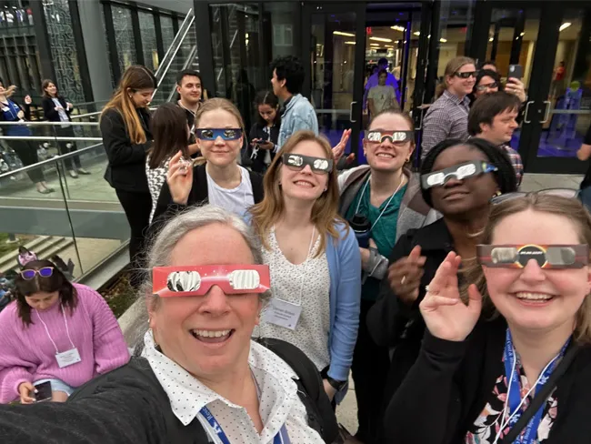 Members of the Stowe Lab wearing eclipse glasses while viewing the 2024 solar eclipse