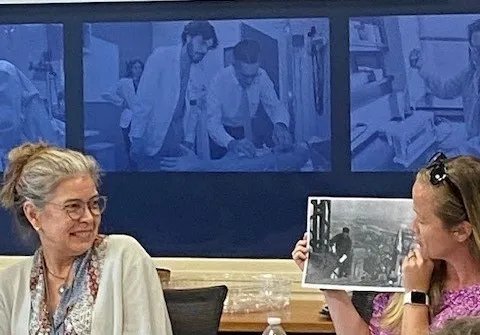 Two women smiling at a photo