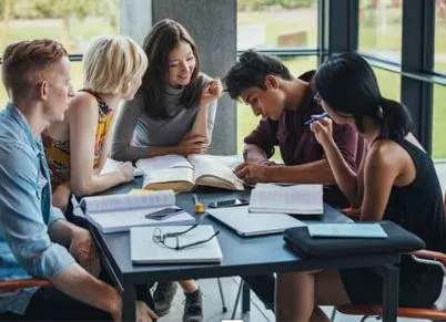 Group of people talking and writing around the table