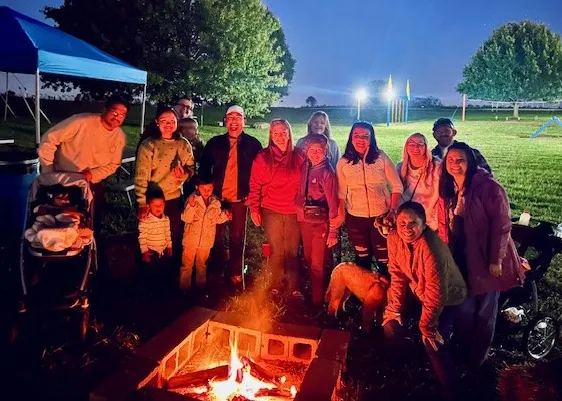 Fellows and Faculty gathered around a campfire during a fall retreat.
