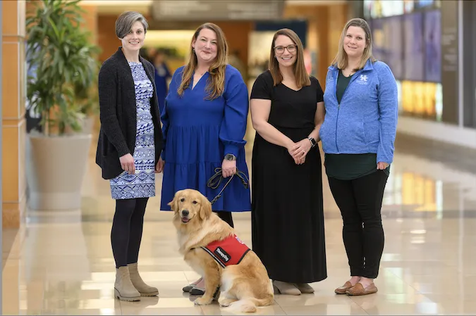 Photo of the Child Abuse Pediatrics Fellowship Team, picturing leaders and dog.