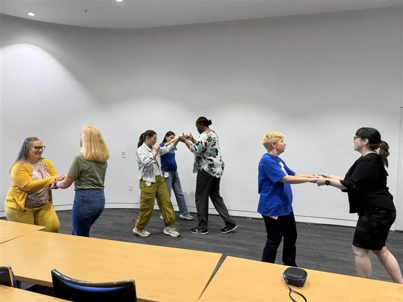 Small group of people dancing inside together