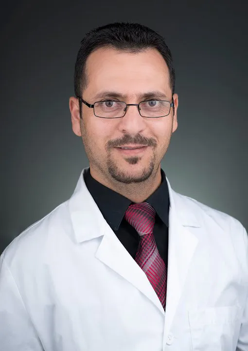 Posed headshot of Dr. Khaleefah in labcoat