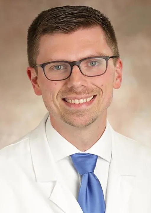 Headshot of Dr. Rose in labcoat