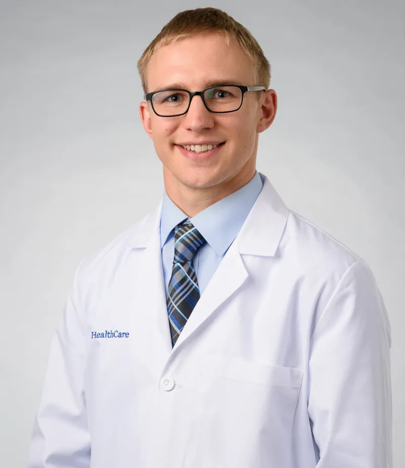 John Bader smiling in white coat