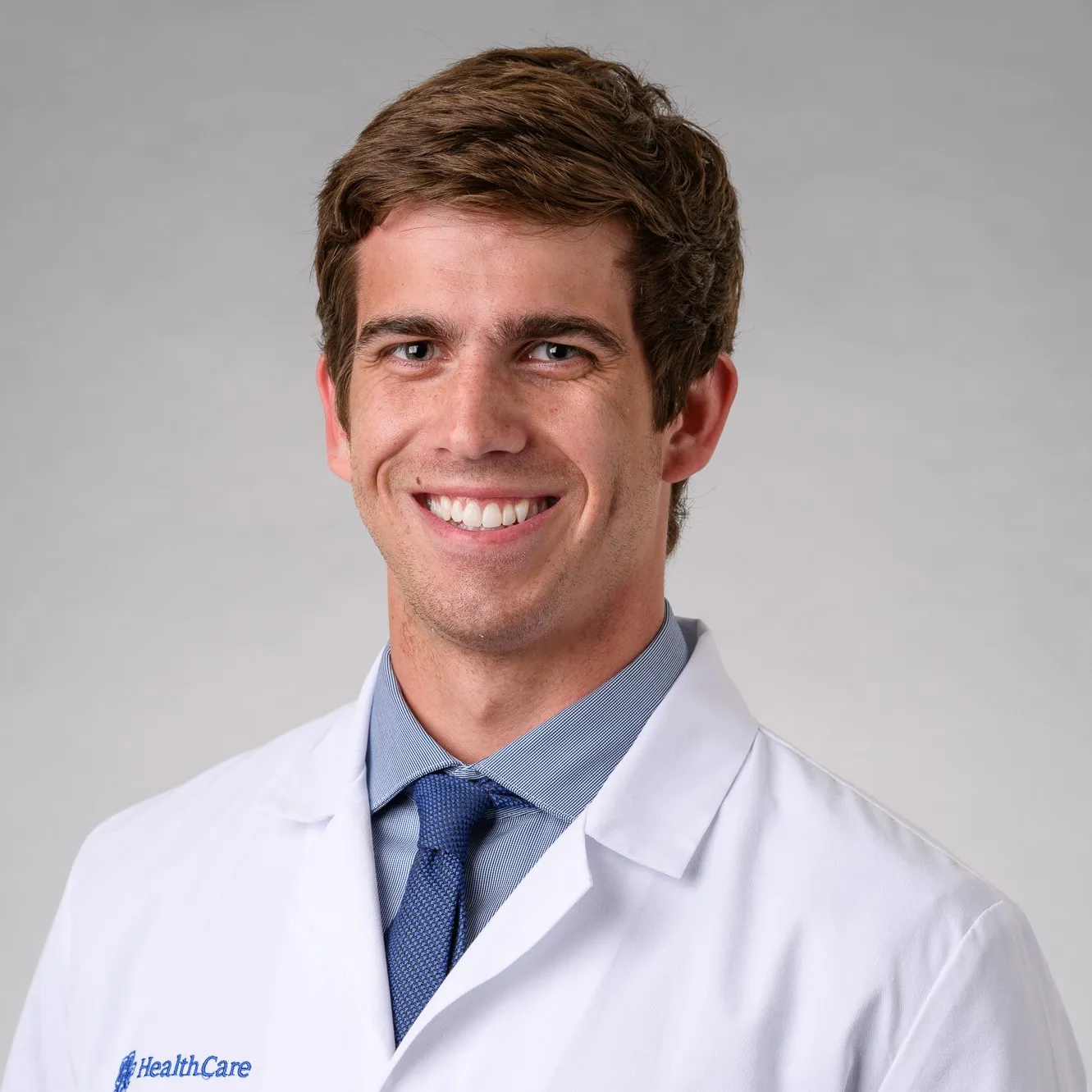 zach tarter smiling in his white coat