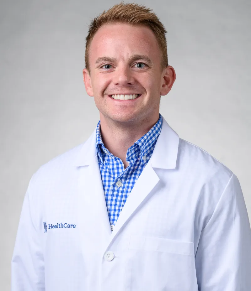 Cody Williams smiling in white coat