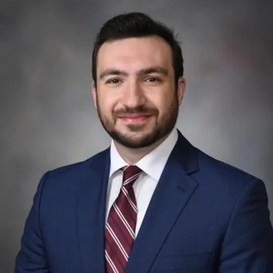 Moayad Al-Sona, in blue suit and red, striped tie.
