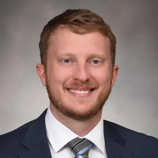 Jason Ballengee in black suit and tie.