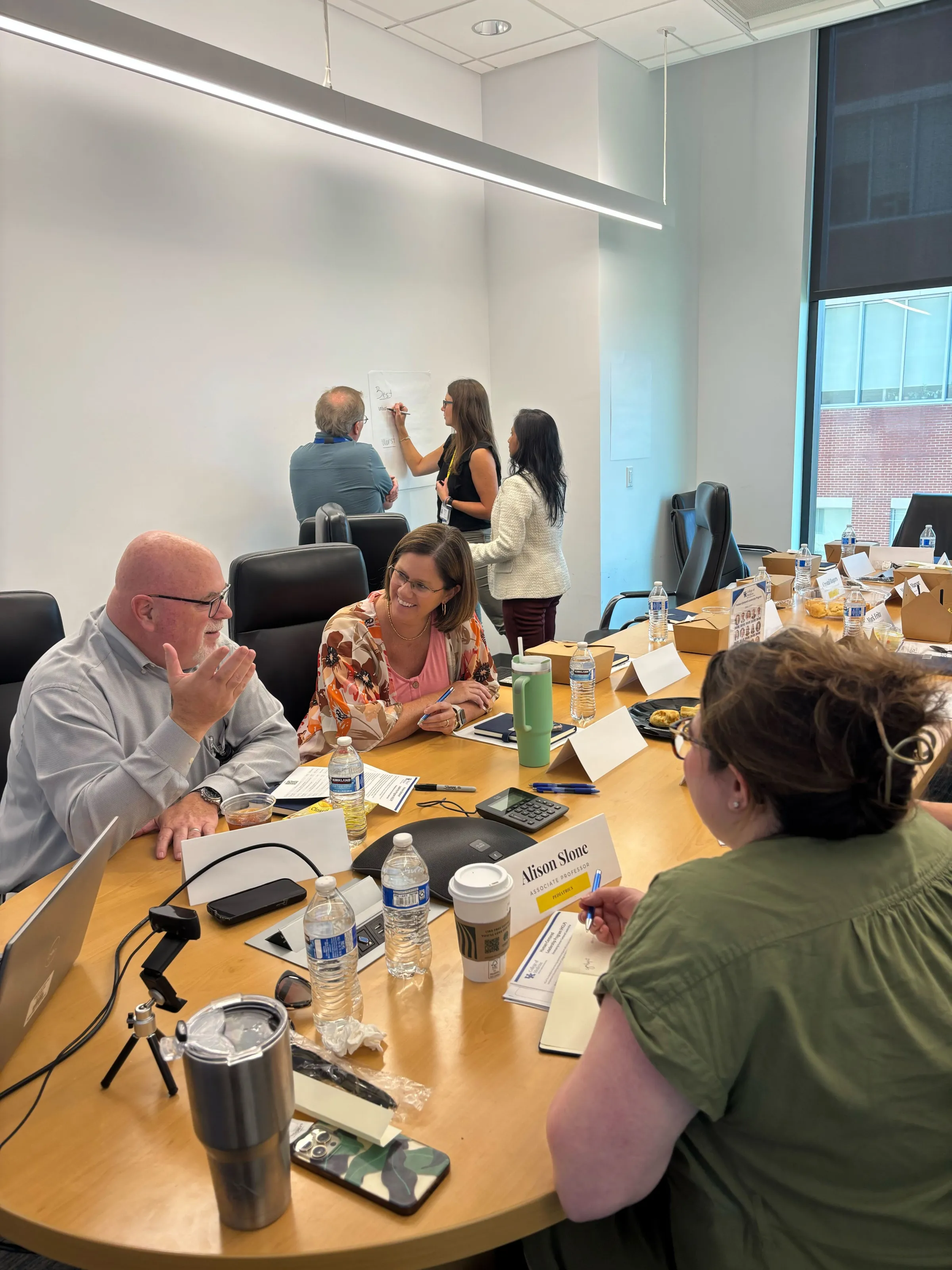 Individuals talking at a table together